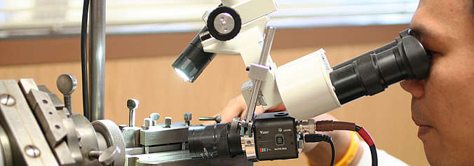 Unia Sektor Industrie - Mann bei der Arbeit am Mikroskop